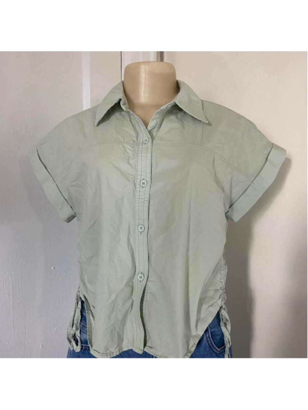 Light green button-up blouse with tie detail on the sides